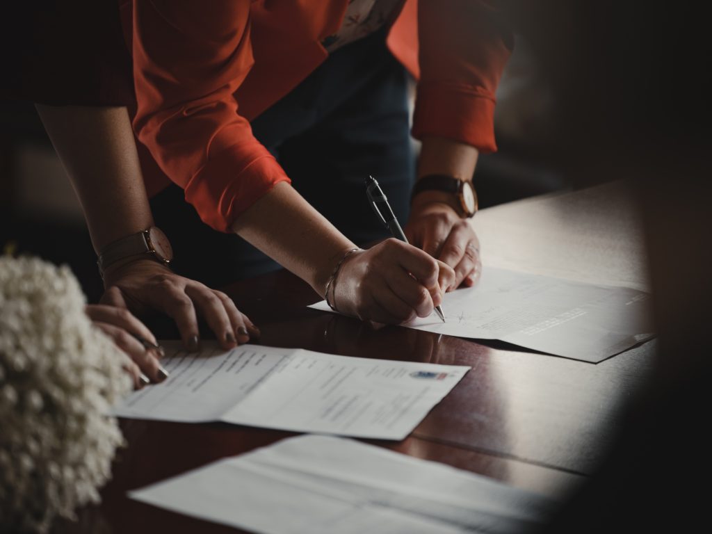 Hands signing document